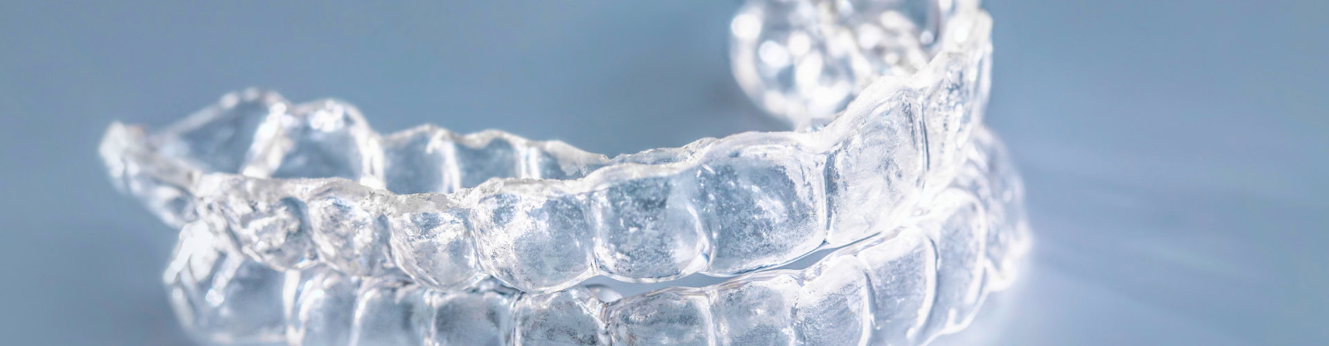Clear aligners laying on surface.